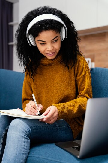 smiley-teenage-girl-with-headphones-laptop-online-school_23-2148827456